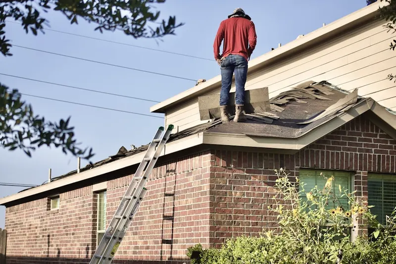 Professional roofer working on a residential roof in Silverado